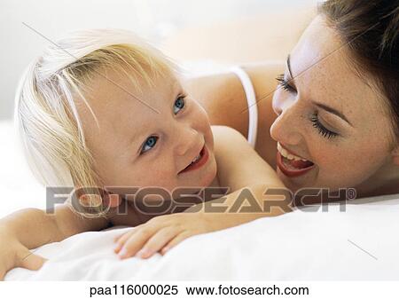 Stock Photography - Woman smiling at baby, close-up. Fotosearch