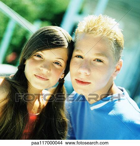 Boy and girl side by side, looking into camera View Large Photo Image Picture - Boy and girl side by side, looking into camera. Fotosearch