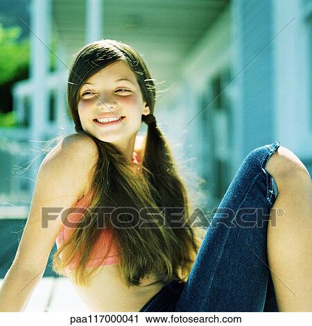 Stock Image - Girl sitting, close-up. Fotosearch
