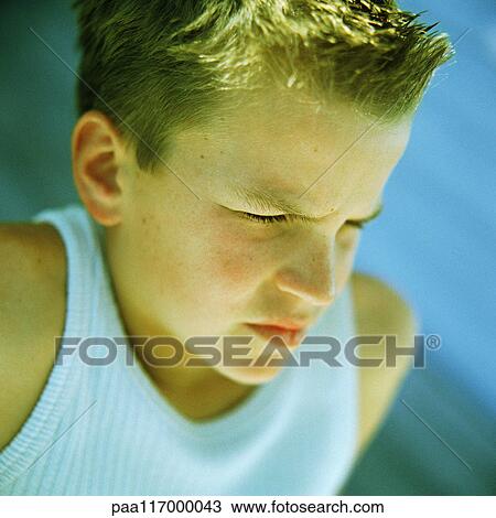 Teenage boy's face, frowning View Large Photo Image Stock Image - Teenage boy's face, frowning. Fotosearch