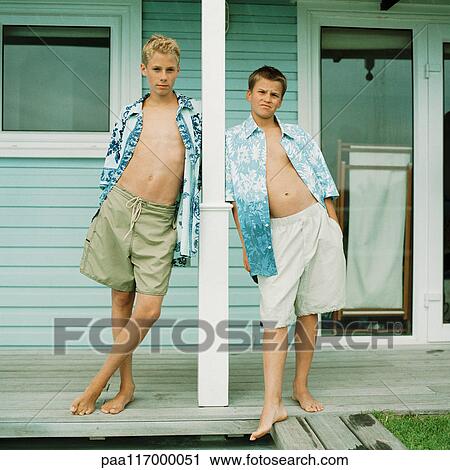 Two boys standing in front of house View Large Photo Image Stock Image - Two boys standing in front of house. Fotosearch