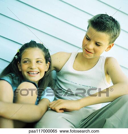 Two children sitting side by side, outside View Large Photo Image Stock Photography - Two children sitting side by side, outside. Fotosearch