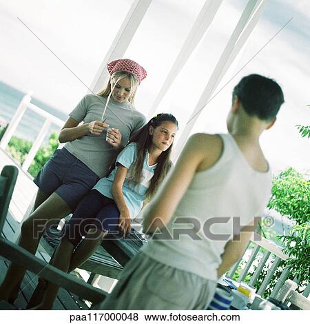 Young people on porch near the ocean View Large Photo Image Stock Photo - Young people on porch near the ocean. Fotosearch
