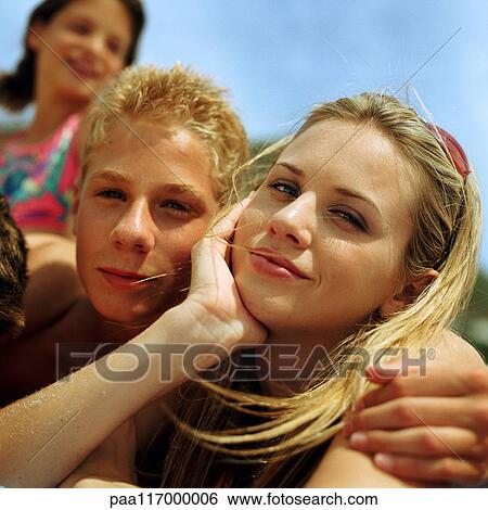 Stock Photograph - Young people outside side by side. Fotosearch