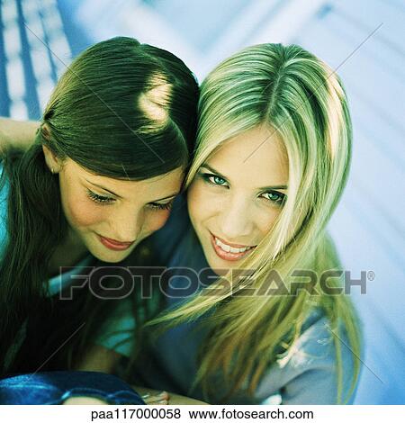 Young woman and girl, side by side, high angle view View Large Photo Image Stock Photo - Young woman and girl, side by side, high angle view. Fotosearch