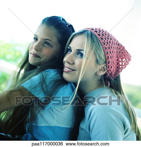 Young woman and girl, side view View Large Photo Image Stock Photograph - Young woman and girl, side view. Fotosearch