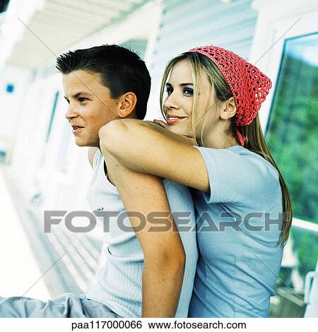 Young woman leaning on teenage boy's back, side view View Large Photo Image Stock Photograph - Young woman leaning on teenage boy's back, side view. Fotosearch