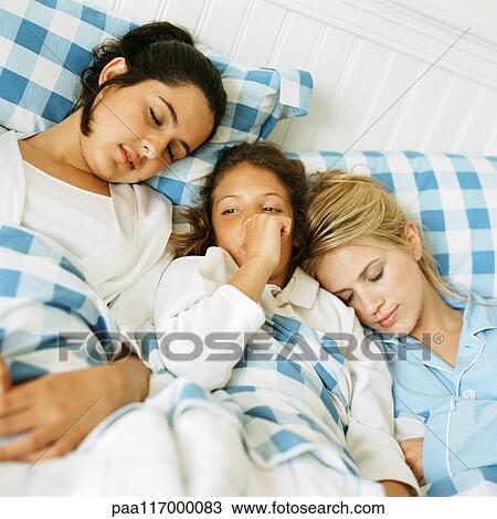 Young woman, teenage girl and girl lying in bed side by side View Large Photo Image Stock Image - Young woman, teenage girl and girl lying in bed side by side. Fotosearch