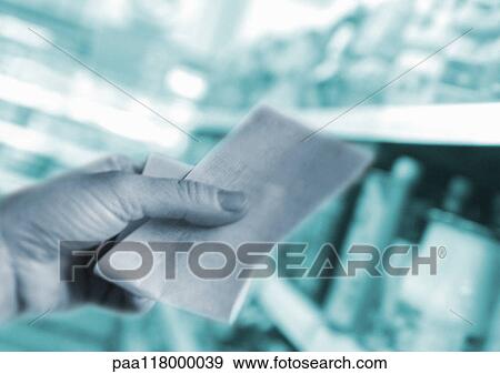 Hand holding receipt and supermarket shelves, close-up View Large Photo Image Stock Photo - Hand holding receipt and supermarket shelves, close-up. Fotosearch