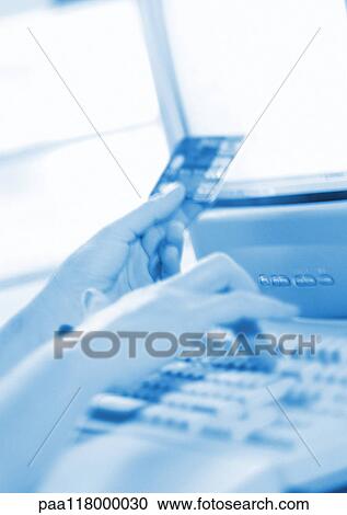 Hands holding credit card and typing on computer keyboard, close-up View Large Photo Image Stock Image - Hands holding credit card and typing on computer keyboard, close-up. Fotosearch