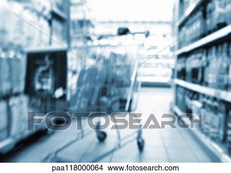 Shopping cart in aisle of supermarket, blurred View Large Photo Image Picture - Shopping cart in aisle of supermarket, blurred. Fotosearch