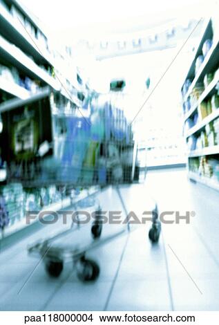 Shopping cart in supermarket, blurred View Large Photo Image Picture - Shopping cart in supermarket, blurred. Fotosearch