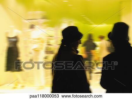 Silhouettes in front of clothing shop window, blurred View Large Photo Image Stock Image - Silhouettes in front of clothing shop window, blurred. Fotosearch