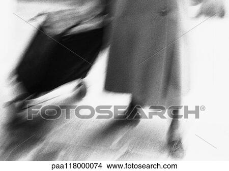 Woman pulling shopping cart, low section, blurred, b&w View Large Photo Image Picture - Woman pulling shopping cart, low section, blurred, b&w. Fotosearch