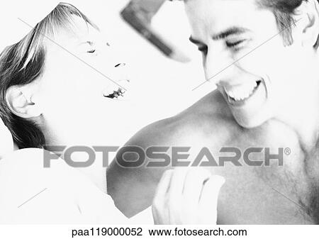 Stock Image - Couple laughing, close-up, b&w. Fotosearch