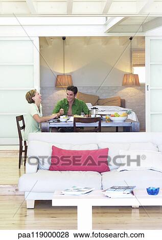 Couple sitting at table View Large Photo Image Stock Photo - Couple sitting at table. Fotosearch