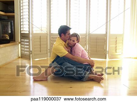 Couple sitting on floor View Large Photo Image Stock Photo - Couple sitting on floor. Fotosearch