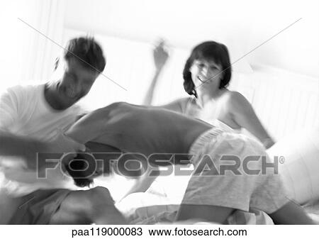 Stock Image - Family playfighting, blurred, b&w. Fotosearch