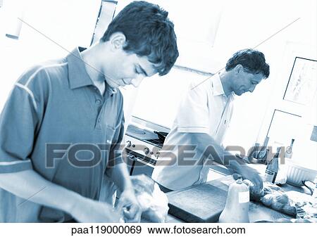 Man and teenage boy cooking View Large Photo Image Stock Photo - Man and teenage boy cooking. Fotosearch
