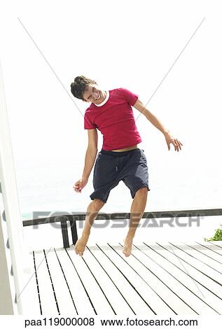 Stock Photo - Teenage boy jumping. Fotosearch