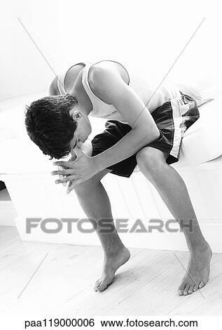 Teenage boy sitting with head down, b&w View Large Photo Image Stock Photograph - Teenage boy sitting with head down, b&w. Fotosearch