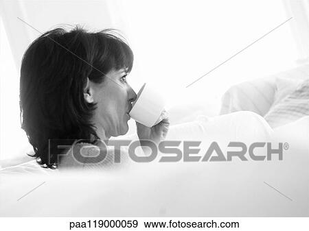 Woman drinking from teacup, side view, b&w View Large Photo Image Stock Photo - Woman drinking from teacup, side view, b&w. Fotosearch