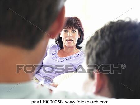 Stock Photo - Woman talking to husband and son. Fotosearch
