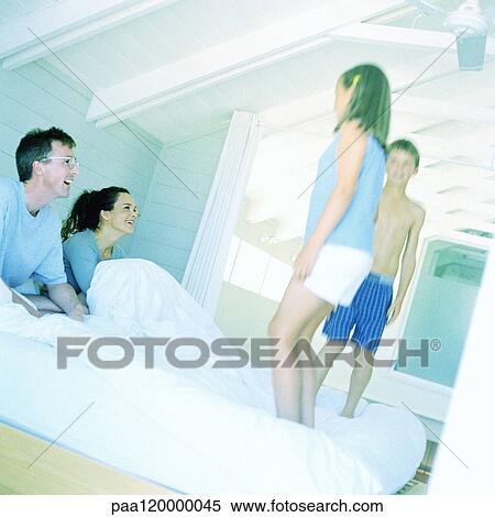 Children standing up on parent's bed View Large Photo Image Stock Photography - Children standing up on parent's bed. Fotosearch