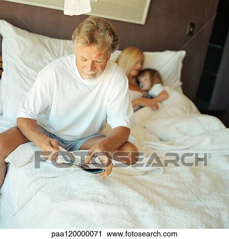 Couple and child on bed View Large Photo Image Stock Image - Couple and child on bed. Fotosearch