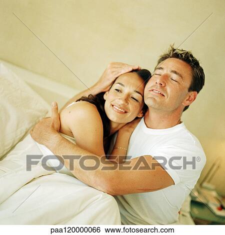 Couple hugging, man closing eyes View Large Photo Image Stock Photograph - Couple hugging, man closing eyes. Fotosearch