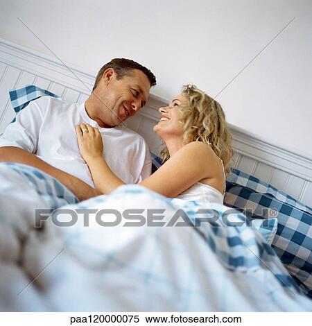 Couple in bed, smiling View Large Photo Image Stock Photography - Couple in bed, smiling. Fotosearch