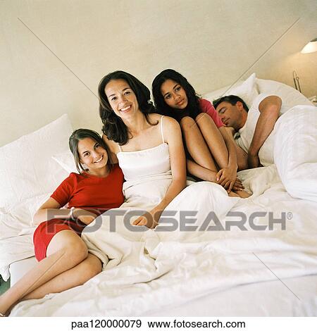 Family on bed View Large Photo Image Stock Photo - Family on bed. Fotosearch