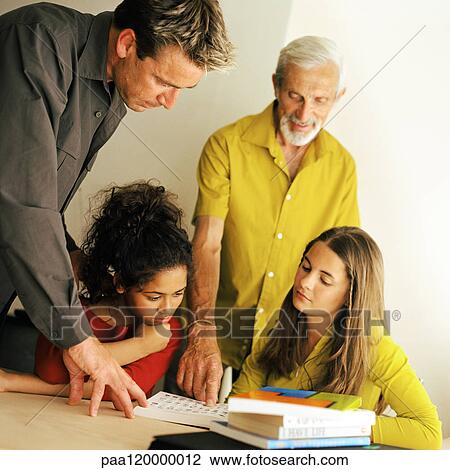 Grandfather, father and daughters looking at book View Large Photo Image Stock Image - Grandfather, father and daughters looking at book. Fotosearch