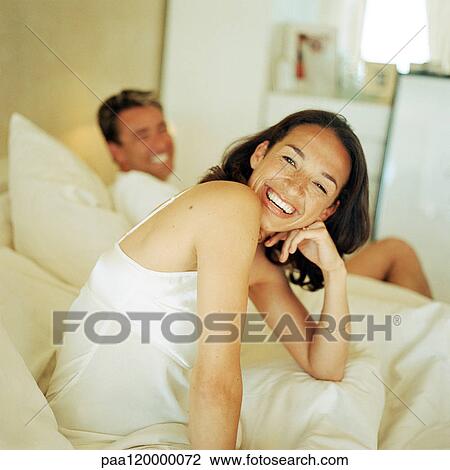 Man and woman on bed, smiling View Large Photo Image Stock Image - Man and woman on bed, smiling. Fotosearch