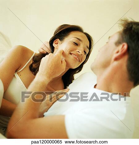 Man touching woman's cheek View Large Photo Image Stock Photography - Man touching woman's cheek. Fotosearch