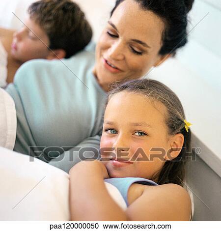 Mother lying in bed between children View Large Photo Image Stock Image - Mother lying in bed between children. Fotosearch