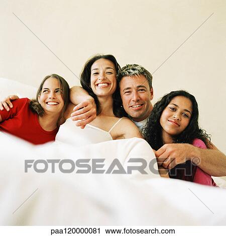 Parents and children lying in bed, arms around each other View Large Photo Image Stock Image - Parents and children lying in bed, arms around each other. Fotosearch
