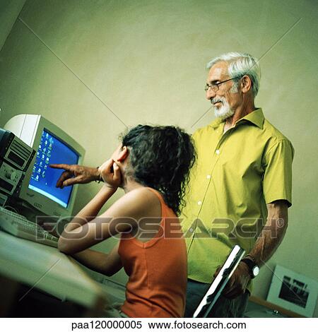 Stock Photography - Senior man and girl looking at computer. Fotosearch