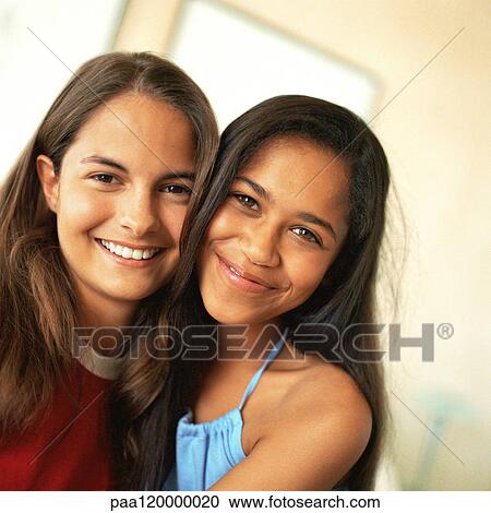 Two girls smiling, close-up, portrait View Large Photo Image Stock Image - Two girls smiling, close-up, portrait. Fotosearch