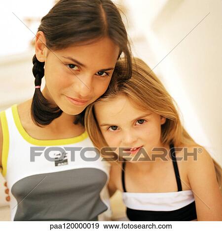 Two girls smiling, close-up, portrait View Large Photo Image Stock Photo - Two girls smiling, close-up, portrait. Fotosearch