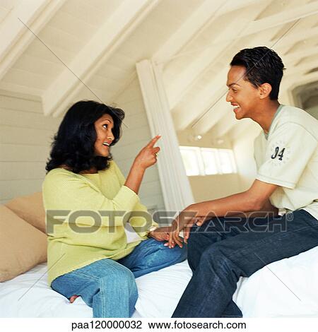 Woman and teenage boy sitting on bed, woman talking and pointing to boy View Large Photo Image Stock Image - Woman and teenage boy sitting on bed, woman talking and pointing to boy. Fotosearch