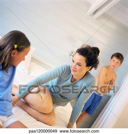 Woman and two children in bedroom View Large Photo Image Stock Photo - Woman and two children in bedroom. Fotosearch
