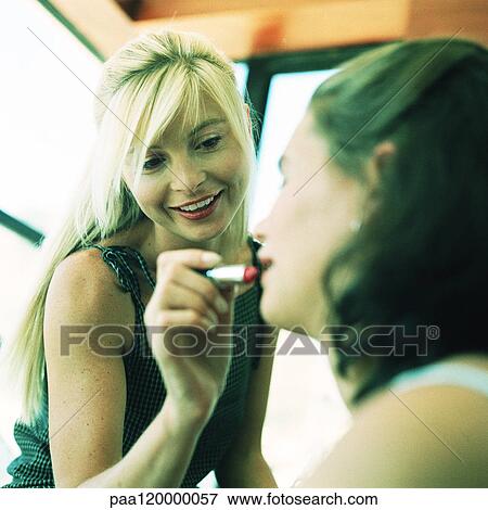 Woman putting lipstick on teenage girl, blurred View Large Photo Image Stock Photo - Woman putting lipstick on teenage girl, blurred. Fotosearch