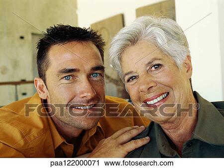 Man and senior woman smiling, portrait View Large Photo Image Stock Image - Man and senior woman smiling, portrait. Fotosearch