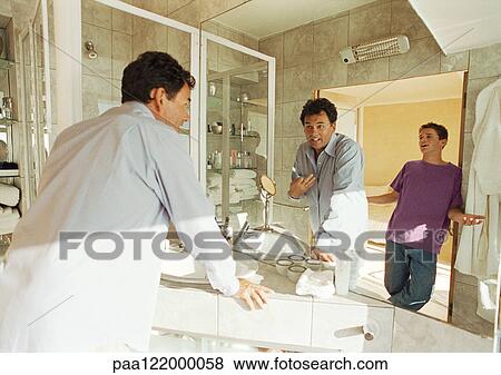 Man and teenage son talking in bathroom View Large Photo Image Stock Photo - Man and teenage son talking in bathroom. Fotosearch
