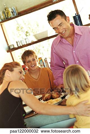 Parents and children having meal View Large Photo Image Stock Image - Parents and children having meal. Fotosearch