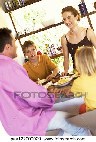 Parents and children having meal View Large Photo Image Stock Photo - Parents and children having meal. Fotosearch