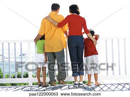 Parents and children looking out to sea, rear view View Large Photo Image Stock Image - Parents and children looking out to sea, rear view. Fotosearch