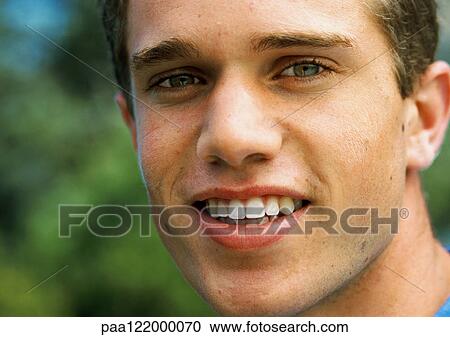 Teenage boy smiling, close-up, portrait View Large Photo Image Stock Image - Teenage boy smiling, close-up, portrait. Fotosearch