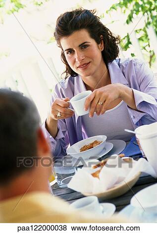 Woman and man having breakfast outside View Large Photo Image Stock Photo - Woman and man having breakfast outside. Fotosearch